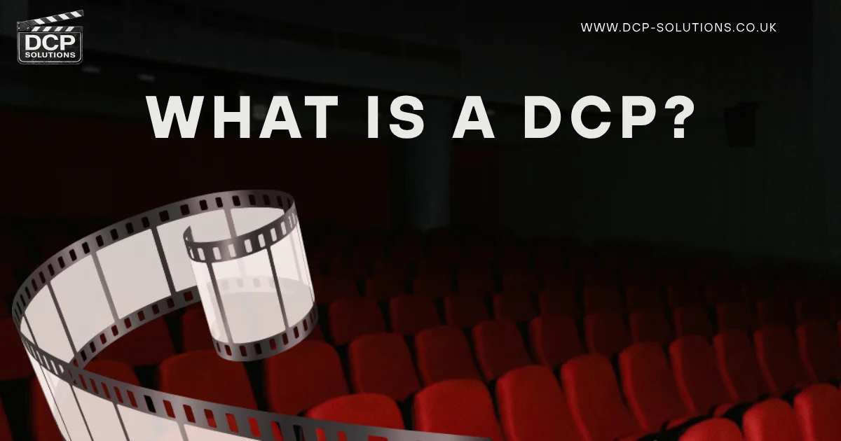 Dark movie theater with rows of red seats and a large film reel in the foreground, visually representing “what is DCP” and how digital cinema content reaches theaters.